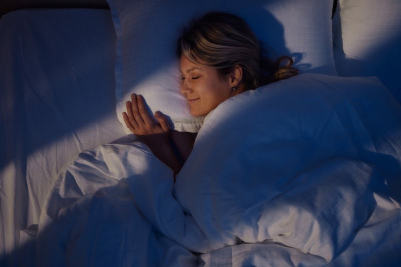 Your HVAC System Can Enhance Sleep. A woman sleeping peacefully.